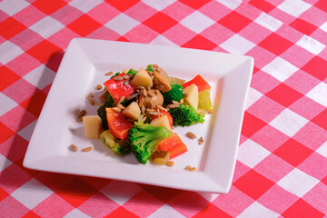 Vegetable salad with broccoli cabbage, cheese, lettuce, mushrooms, cucumber, sunflower seeds and fresh parsley.