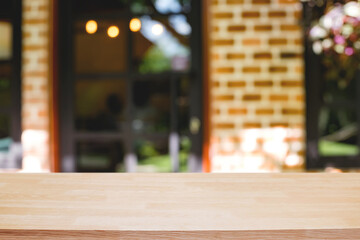 Empty wooden table space platform and blurred restaurant or coffee shop background for product display montage.