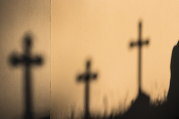 Shadows of crosses on the wall.