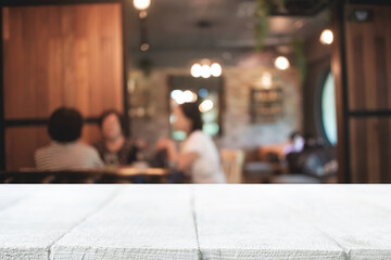 Empty wooden desk space platform and blurred restaurant or coffee shop background for product display montage.