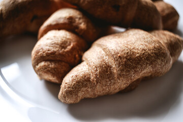Croissants on a white plate. Fresh bakery