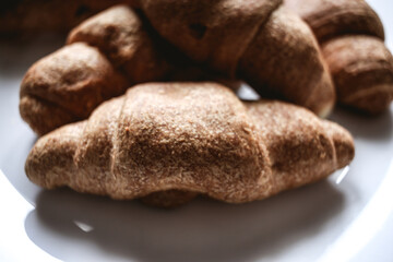 Croissants on a white plate. Fresh bakery
