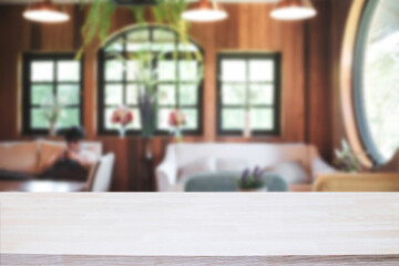 Empty wooden table space platform and blurred restaurant or coffee shop background for product display montage.