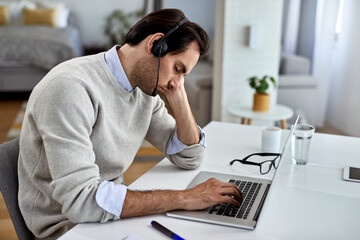 Obraz na płótnie Canvas Tired businessman fell asleep after working on laptop at home.