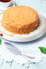 Homemade honey cake with sour cream. Black tea and mint
