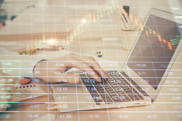Double exposure of stock market graph with man working on laptop on background. Concept of...