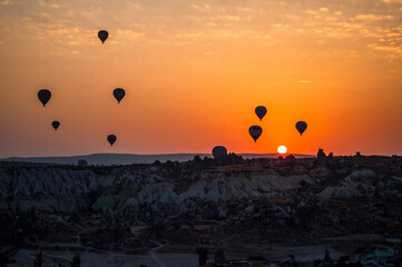 Sunrise in Cappadocia Turkey. Hot air balloons in Goreme valley. Flight above mountains. travel destination. Colorful balloon.