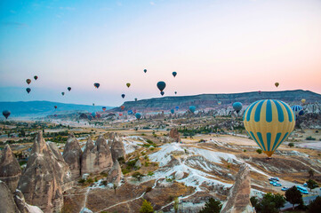 Sunrise in Cappadocia Turkey. Hot air balloons in Goreme valley. Flight above mountains. travel destination. Colorful balloon.