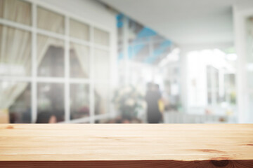 Empty wooden table space platform and blurred restaurant or coffee shop background for product display montage.