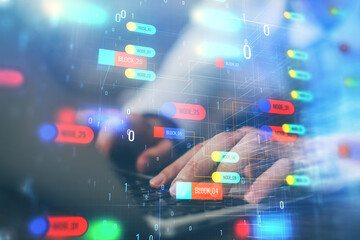 Multi exposure of data internet theme hologram with man working on computer on background. Concept of innovation.