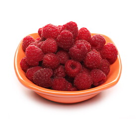 Fresh raspberries in porcelain bowl, pot isolated on white background