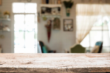 Empty wooden table space platform and blurred restaurant or coffee shop background for product display montage.