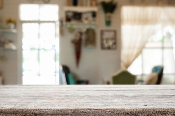 Empty wooden table space platform and blurred restaurant or coffee shop background for product display montage.