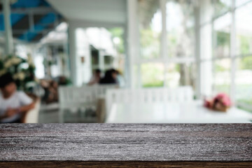 Empty wooden table space platform and blurred restaurant or coffee shop background for product display montage.