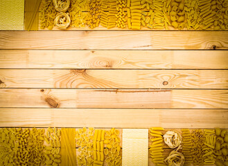 Background of wood natural panel full of kind of pasta making the borders. Healthy mediterranean diet