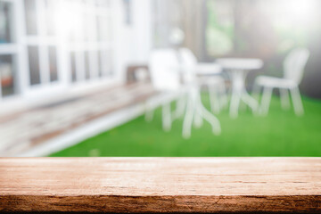 Empty wooden table space platform and blurred restaurant or coffee shop background for product display montage.