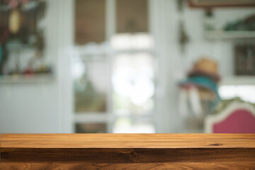 Empty wooden table space platform and blurred restaurant or coffee shop background for product display montage.