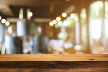 Empty wooden table space platform and blurred restaurant or coffee shop background for product display montage.