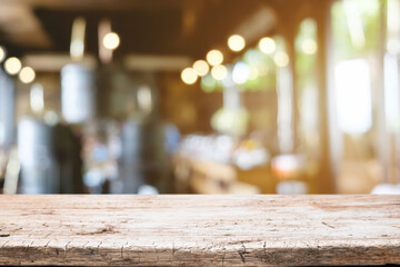 Empty wooden table space platform and blurred restaurant or coffee shop background for product display montage.