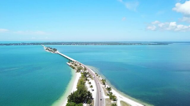 Aerial panoramic view of road and bridge leading to a big island in the ocean. Captiva, Florida.