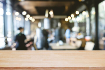 Empty wooden table space platform and blurred restaurant or coffee shop background for product display montage.