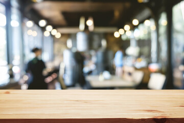 Empty wooden table space platform and blurred restaurant or coffee shop background for product display montage.