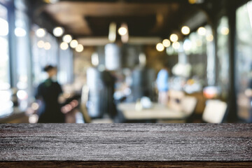 Empty wooden table space platform and blurred restaurant or coffee shop background for product display montage.