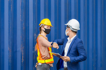 Engineer and worker wearing protection face mask against coronavirus and shaking elbows, New novel greeting to avoid the spread of coronavirus