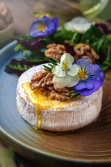 Baked Brie Cheese with Honey, Nuts and White Wine. Beautiful still life for poster or wallpaper for the kitchen