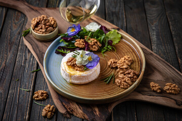 Baked Brie Cheese with Honey, Nuts and White Wine. Beautiful still life for poster or wallpaper for the kitchen