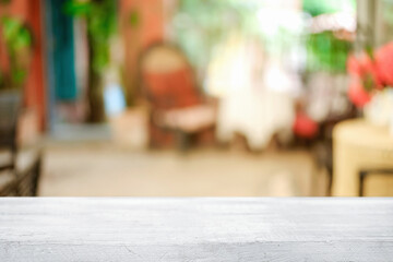Empty wooden table space platform and blurred restaurant or coffee shop background for product display montage.