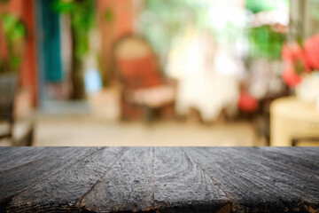 Empty wooden table space platform and blurred restaurant or coffee shop background for product display montage.