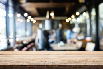 Fototapeta na wymiar Desk space platform over blurred restaurant or coffee shop background for product display montage.