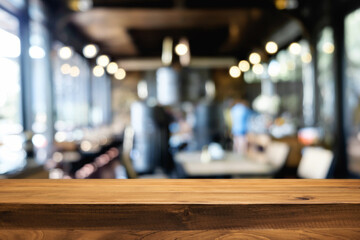 Desk space platform over blurred restaurant or coffee shop background for product display montage.