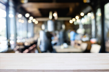 Desk space platform over blurred restaurant or coffee shop background for product display montage.