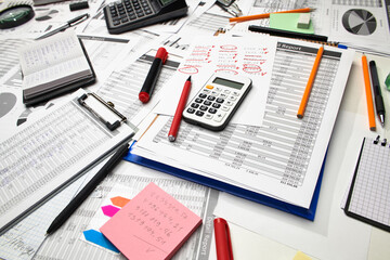 Top view of office employee's desk - work with financial reports, analysis and accounting, tables and graphs, various office items for bookkeeping
