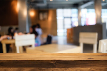 Empty wooden table space platform and blurred restaurant or coffee shop background for product display montage.