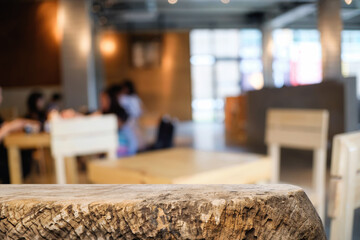 Empty wooden table space platform and blurred restaurant or coffee shop background for product display montage.