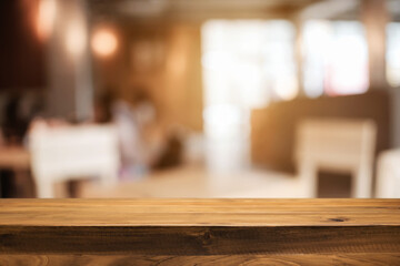 Empty wooden table space platform and blurred resturant or coffee shop background for product display montage.