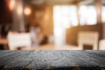 Fototapeta na wymiar Empty wooden table space platform and blurred resturant or coffee shop background for product display montage.