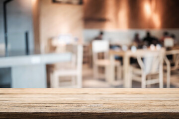 Empty wooden table space platform and blurred restaurant or coffee shop background for product display montage.