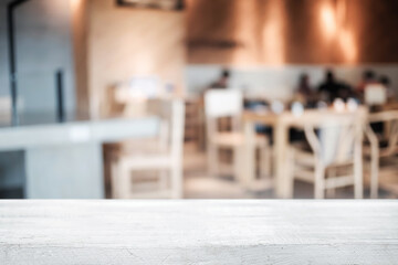 Empty wooden table space platform and blurred restaurant or coffee shop background for product display montage.