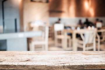Empty wooden table space platform and blurred restaurant or coffee shop background for product display montage.