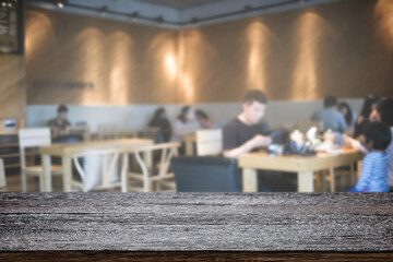 Empty wooden desk space platform with blur restaurant or coffee shop background for product display montage.