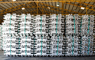 Aluminum ingot bar stack in warehouse for supplying to factory. Distribution warehouse and...