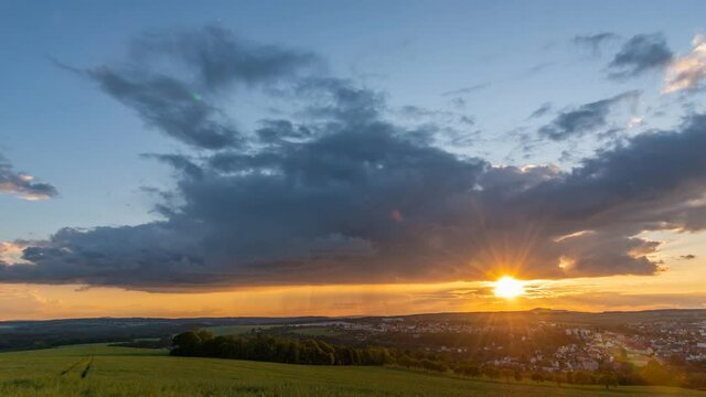 sunset over czech town stribro with moving clouds and rain time lapse