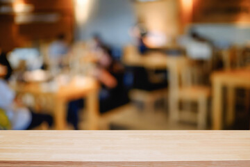 Naklejka na ściany i meble Empty wooden table space platform and blurred resturant or coffee shop background for product display montage.