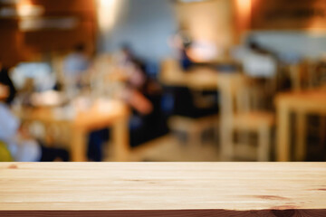 Empty wooden table space platform and blurred resturant or coffee shop background for product display montage.