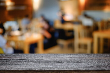 Empty wooden table space platform and blurred resturant or coffee shop background for product display montage.