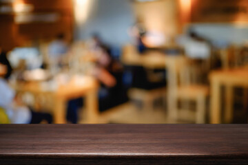Empty wooden table space platform and blurred resturant or coffee shop background for product display montage.